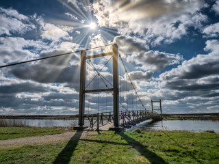 Fototapeta na wymiar Kong Hans suspension bridge in Skjern meadows Ringkoebing, Denmark