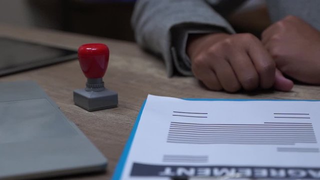 puts a seal on the contract. Slow motion. Close up