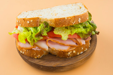 Sandwich of tomato, lettuce and smoked turkey