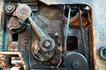 Moving gears of a vintage machine driven by steam engine