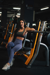 Fototapeta na wymiar Fitness woman on training. Young woman in the gym. 