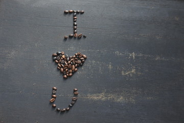 the words "i love you" with coffee beans on a black background  