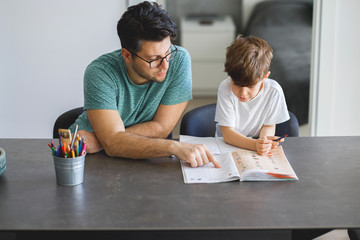 Father homeschooling his son