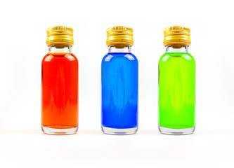 Food coloring in glass bottles on white background isolate, yellow, blue, green, three bottles of food coloring