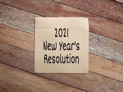New Year resolution concept. 2021 New Year’s Resolution written on a paper. Vintage styled background.