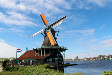 View of traditional Dutch windmills along the canal in spring at the Zaanse Schans, Zaandam, Netherlands