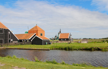 View of traditional Dutch farm houses along a canal in spring at the Zaanse Schans, Zaandam, Netherland