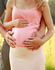 Loving pregnant couple in nature