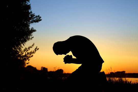 silhouette  man praying