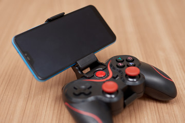red gamepad with a smartphone © Albert