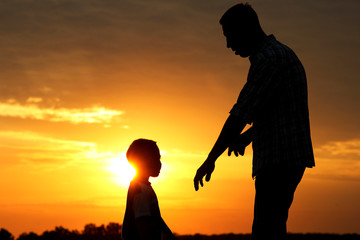 silhouette of father and son  on sunset