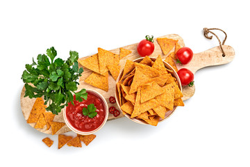 Nachos Mexican corn chips with spicy salsa cherry tomato dip sauce. Vegan healthy nachos snack, cilantro on wooden board isolated on white background, top view. Tortilla nacho crisps in bowl.