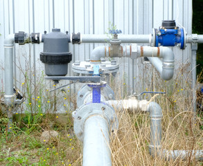 Rusty Water pump station and pipeline on roof deck of water tank for industrial work, drought...