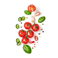 Fototapeta premium Tomato, basil, spices, chili pepper, garlic. Vegan diet food, creative composition isolated on white. Fresh basil, herb, tomatoes, cooking concept, top view.