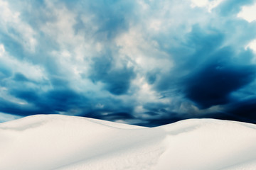 Fototapeta na wymiar Winter Landscape with Snow Dunes and Cloudy Sky on Background