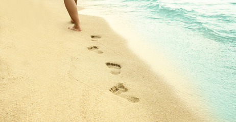 footprints in the sand on the beach