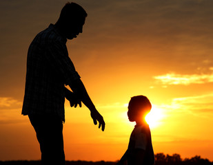 silhouette of father and son  on sunset