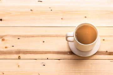 hot coffee on wood table with smoke in the mug cup with natural light in the morning