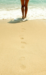 footprints in the sand on the beach