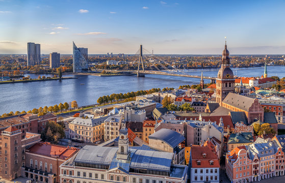 Riga, Latvia. Aerial panoramic view from the tower of St. Peter's Church to the city, Daugava river, historical centre with old buildings and colourful roofs in the foreground. Travel Europe. 