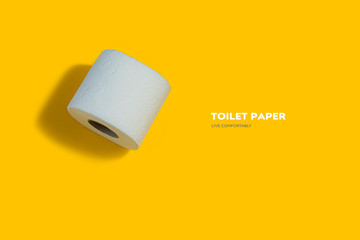 Roll of toilet paper on top on a yellow background for advertising