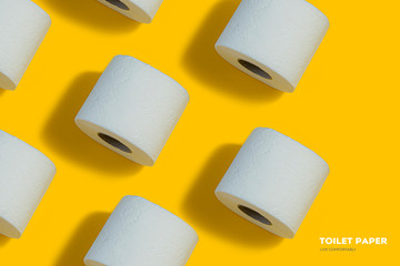 Toilet paper pattern on top on yellow background for banner or advertisement.
