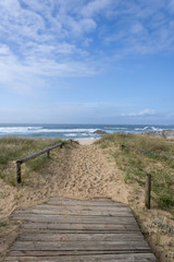 Fototapeta na wymiar Dunes of Corrubedo, beach and walk, Galicia, Spain. Beautiful wooden walk path in dune beach in the north of Spain. 