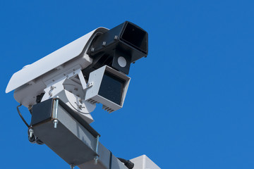 Speed camera. Close-up with details, blue sky background.