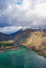 Obraz premium Aerial view of Almsee lake in the austrian alps during Spring