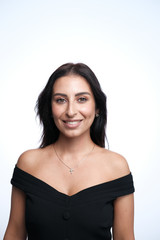 A large portrait of a middle-aged woman (30-35 years old) with dark hair and brown eyes in a black dress on a light background.