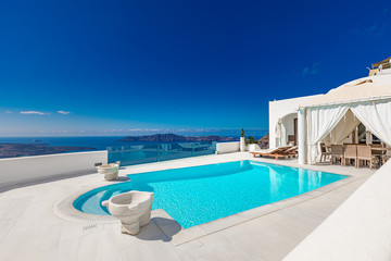 Luxury summer travel and vacation landscape. Swimming pool with sea view. White architecture on Santorini island, Greece. Beautiful landscape with sea view