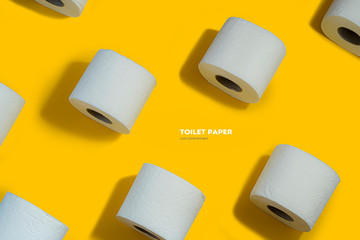 Toilet paper pattern on top on yellow background for banner or advertisement.