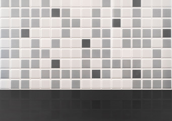 Black table on the background of gray tiles in the bathroom or kitchen