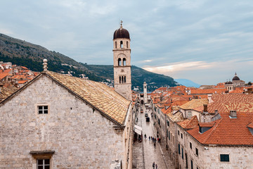 Fototapeta premium top view of the red tiled roofs and the main street of the ancient Croatian city of Dubrovnik