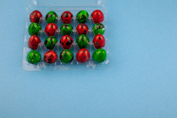 Easter eggs background. Green and red eggs. Colorful Quail colored eggs. Place for text. Different little painted egg set. Dietary nutrition. 