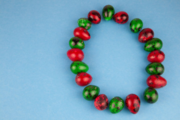 Easter eggs background. Green and red eggs. Colorful Quail colored eggs. Place for text. Different little painted egg set. Dietary nutrition. 