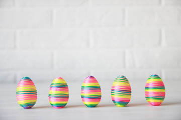 Colorful easter eggs in row on white background