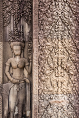 Fototapeta na wymiar Ancient Khmer carving/relief of goddess. Wall of Temple Angkor wat, Siem Reap, Cambodia.