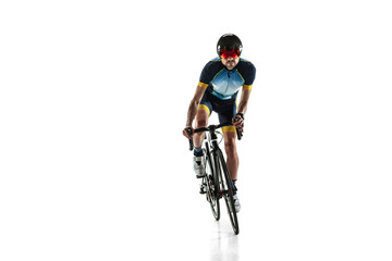 Obraz na płótnie Canvas Triathlon male athlete cycle training isolated on white studio background. Caucasian fit triathlete practicing in cycling wearing sports equipment. Concept of healthy lifestyle, sport, action, motion.