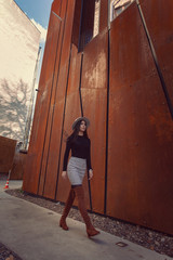 Fototapeta na wymiar Beautiful girl model posing against the background of the modern building