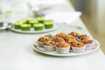 Plate with freshly baked sweet muffins. Sweet pastries, recipes, cooking