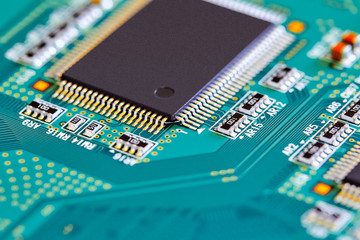 Electronic circuit board with electronic components such as chips close up. Blurry background.	