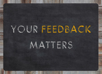 your feedback matters sign - white chalk text on a vintage slate blackboard