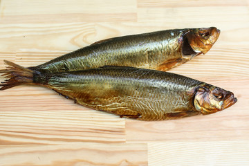  salted, smoked and dried fish, beer snacks, tasty fish on a wooden board
