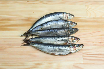  salted, smoked and dried fish, beer snacks, tasty fish on a wooden board