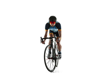 Triathlon male athlete cycle training isolated on white studio background. Caucasian fit triathlete practicing in cycling wearing sports equipment. Concept of healthy lifestyle, sport, action, motion.