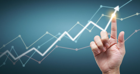 Hand touching  graphs of financial indicator and accounting market economy analysis chart