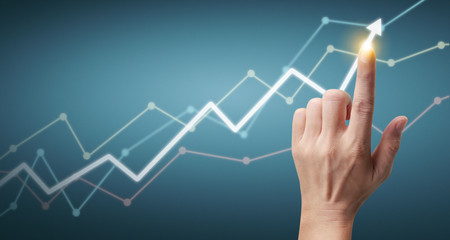 Hand touching  graphs of financial indicator and accounting market economy analysis chart