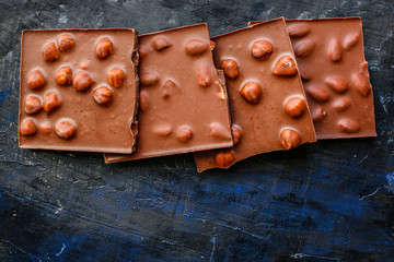 chocolate bar hazelnuts and almonds (delicious sweet dessert snack) menu concept. background. top view. copy space for text