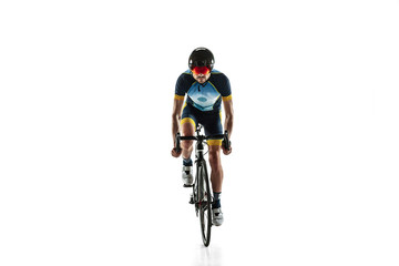 Fototapeta premium Triathlon male athlete cycle training isolated on white studio background. Caucasian fit triathlete practicing in cycling wearing sports equipment. Concept of healthy lifestyle, sport, action, motion.